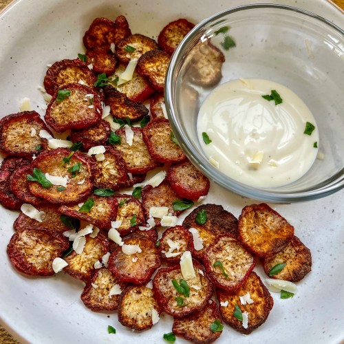 Air Fried Radish Chips in a white bowl with some ranch and parsley and parm for garnish