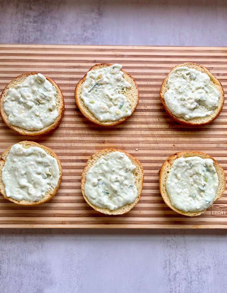 Brioche buns with avocado blue cheese dressing smeared on them