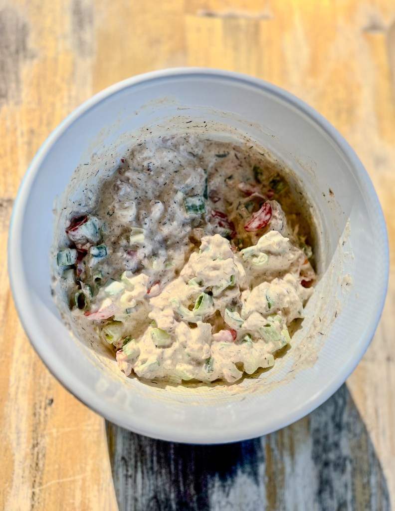 Spicy tuna pasta salad in a bowl before being refrigerated.