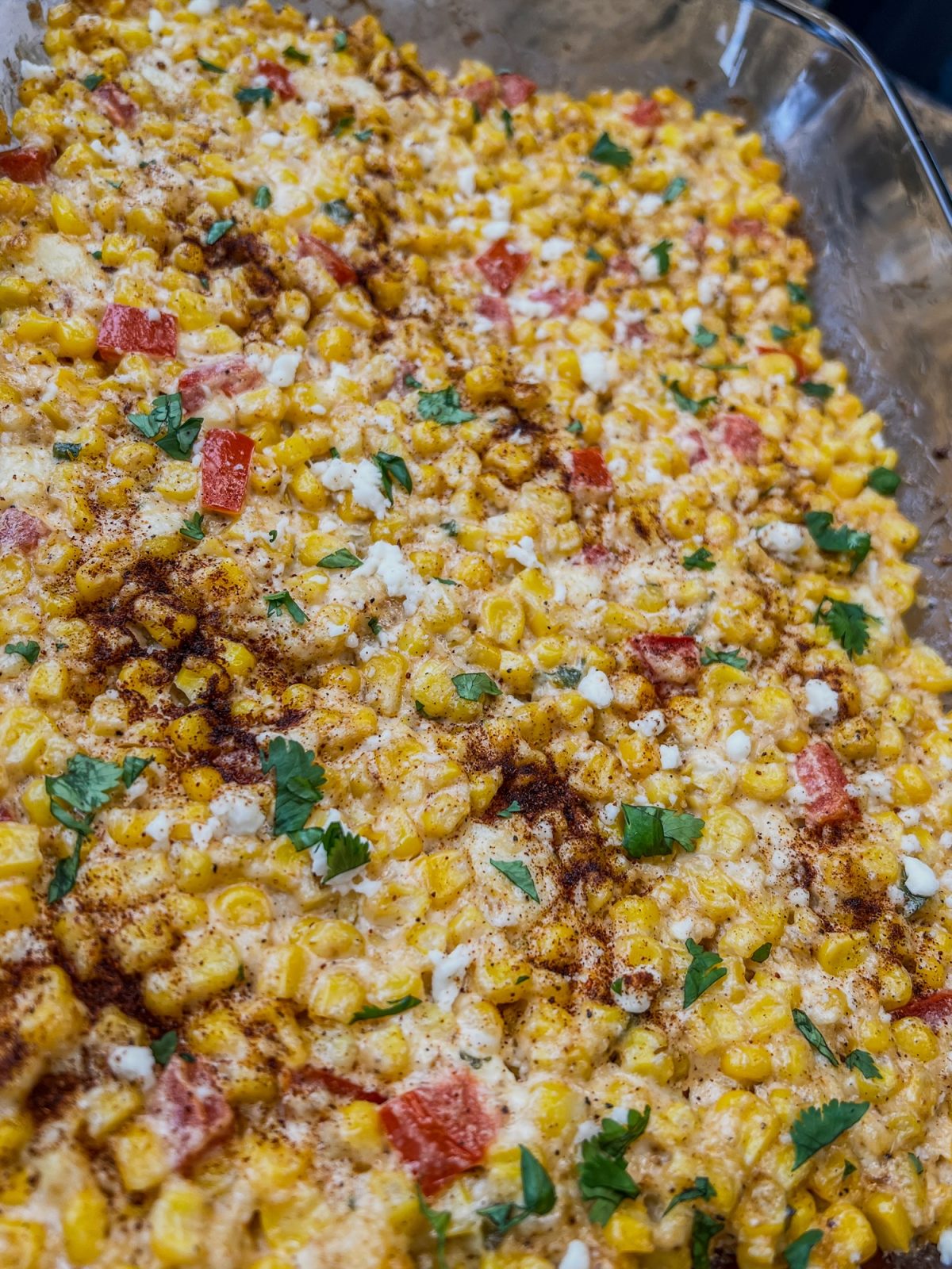 Street corn casserole in a baking dish on a wooden table