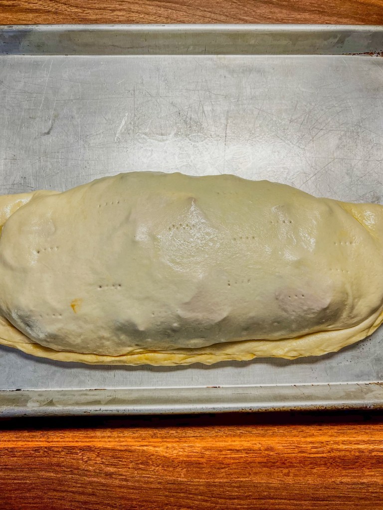 An uncooked stromboli ready to go into the oven