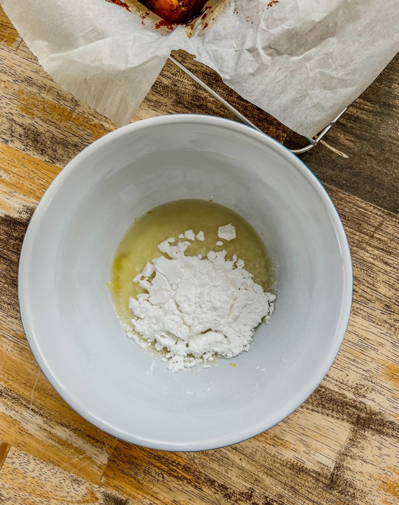 Lemon icing being mixed up in a bowl