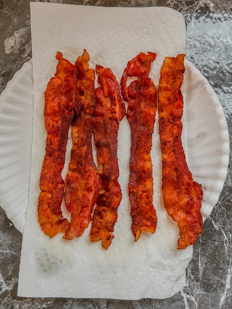 Crispy bacon on a paper towel lined plate