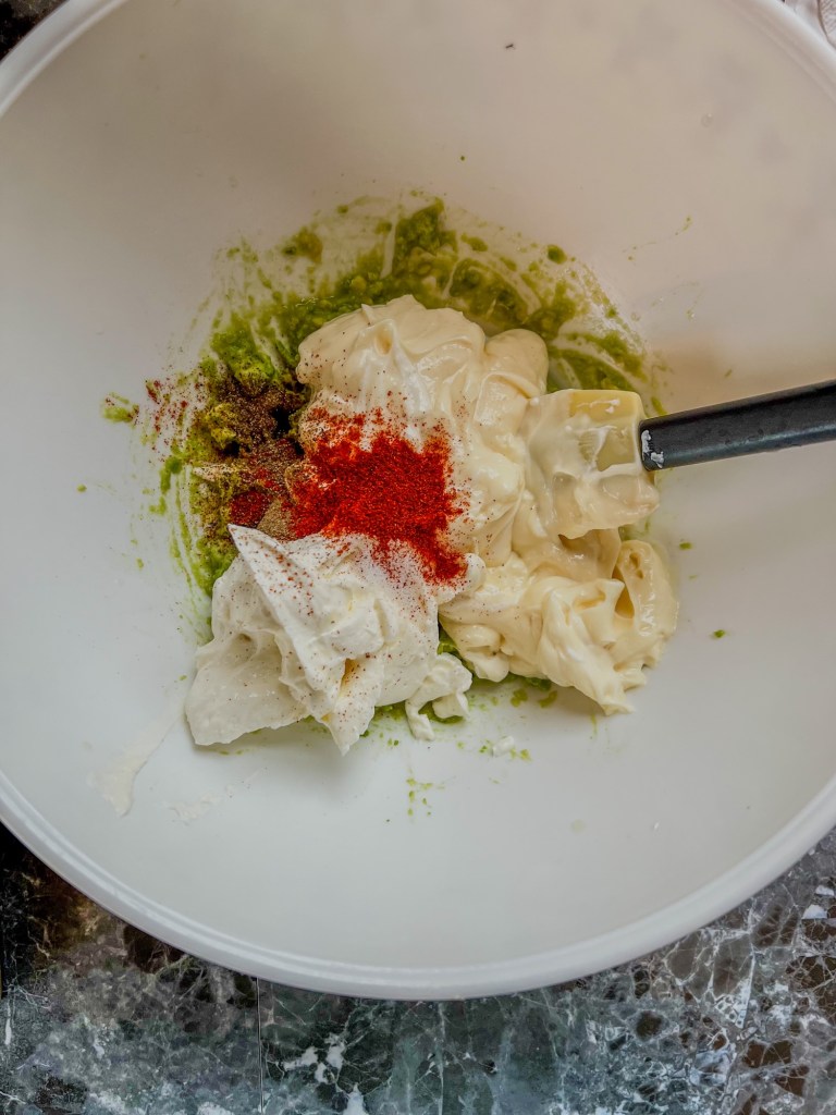 Sour cream, mayo, avocado, lime juice, and spices in a mixing bowl before being combined
