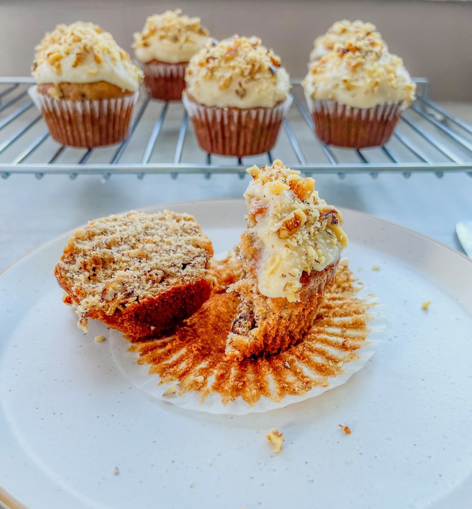 Banana walnut cupcakes with cream cheese frosting and chopped toasted walnuts on top
