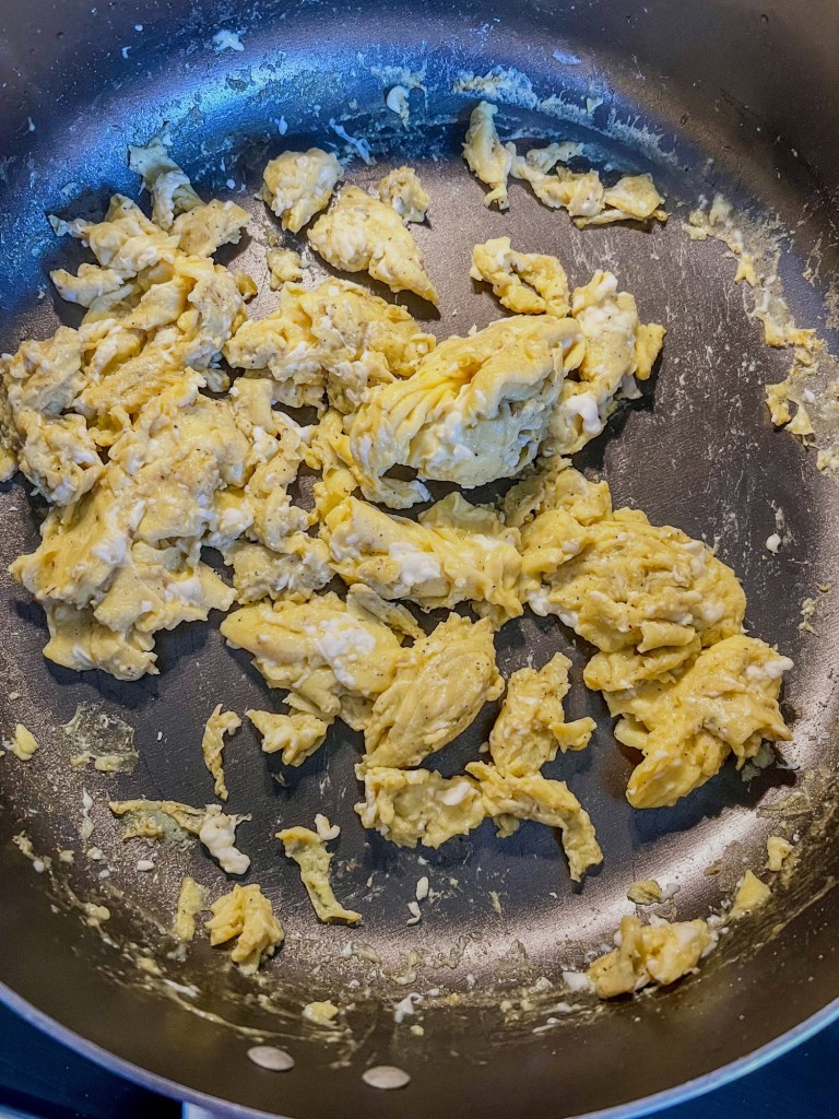 Freshly cooked scrambled eggs in a skillet