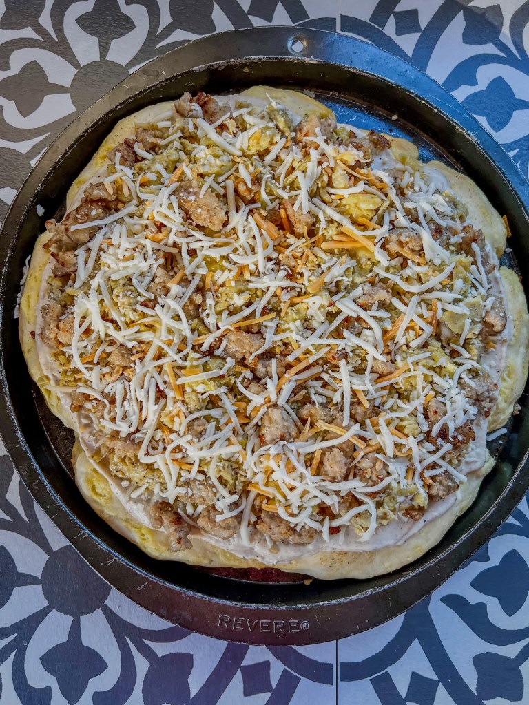 Breakfast pizza before going into the oven to be baked