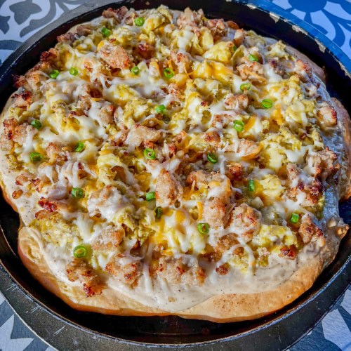 Biscuits and gravy breakfast pizza in a pan on a countertop