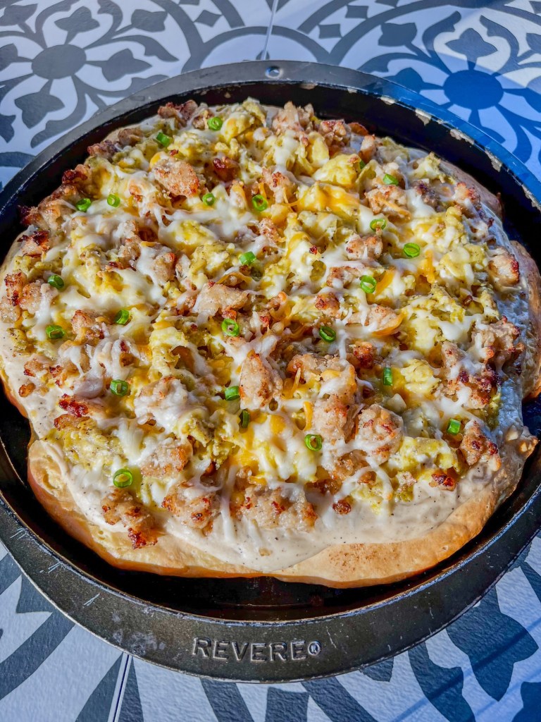 Biscuits and gravy breakfast pizza in a pan on a countertop