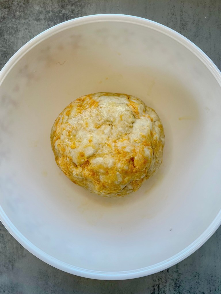 Dough ball for cheddar bagels in a mixing bowl