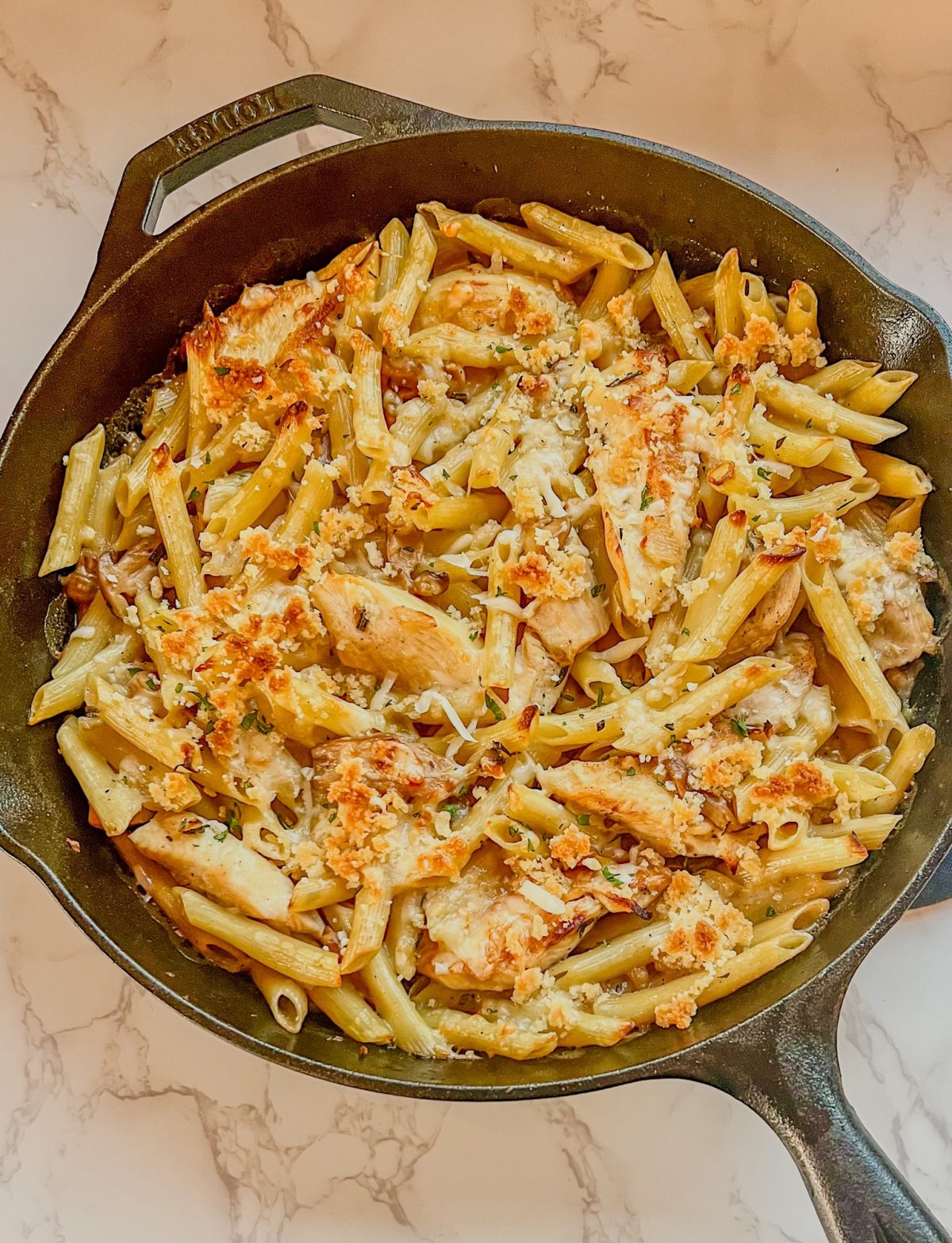 Chicken Marsala Bake in a cast iron skillet on a marble countertop