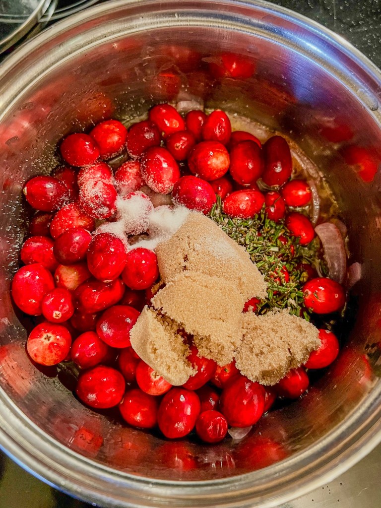 Cranberry and onion compote cooking in a saucepan