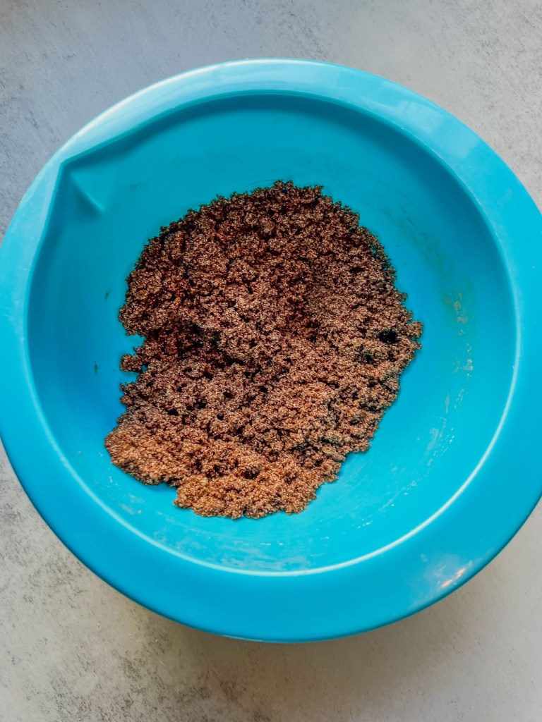 Cinnamon roll filling in a blue mixing bowl