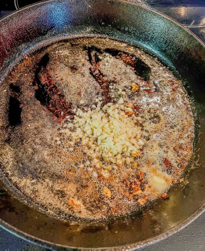 Butter and garlic in a cast iron skillet on the stove