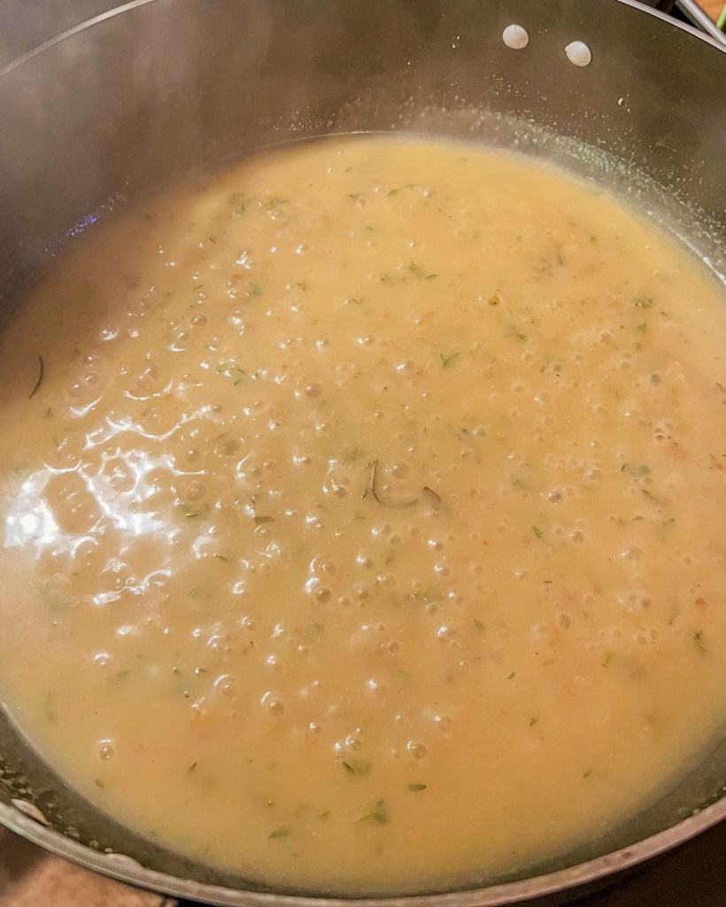 Gravy simmering in a skillet on the stove