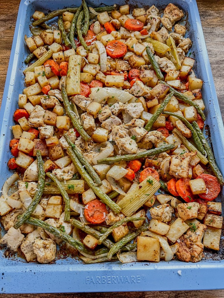 Harvest sheet pan dinner on a blue baking sheet after being baked