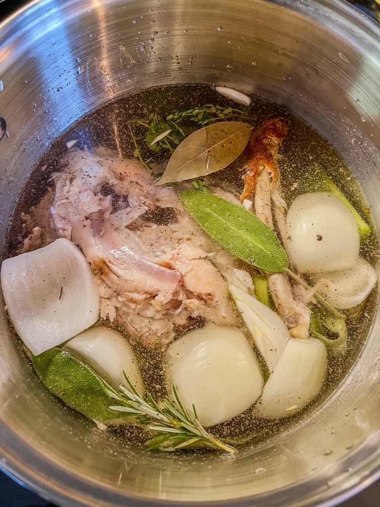 Ingredients to make turkey stock in a large pot on the stove
