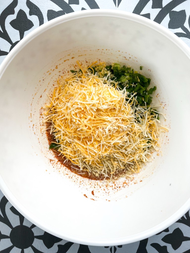 Ingredients to make jalapeño cheddar meatloaf in a mixing bowl