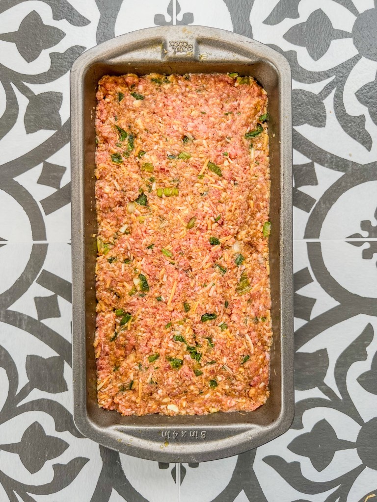 Meatloaf in a pan before glaze is added to the top