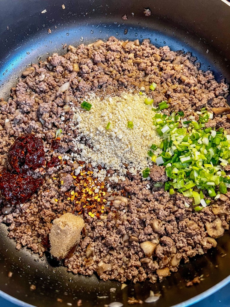 Filling for stuffed mushrooms in a skillet before being mixed up