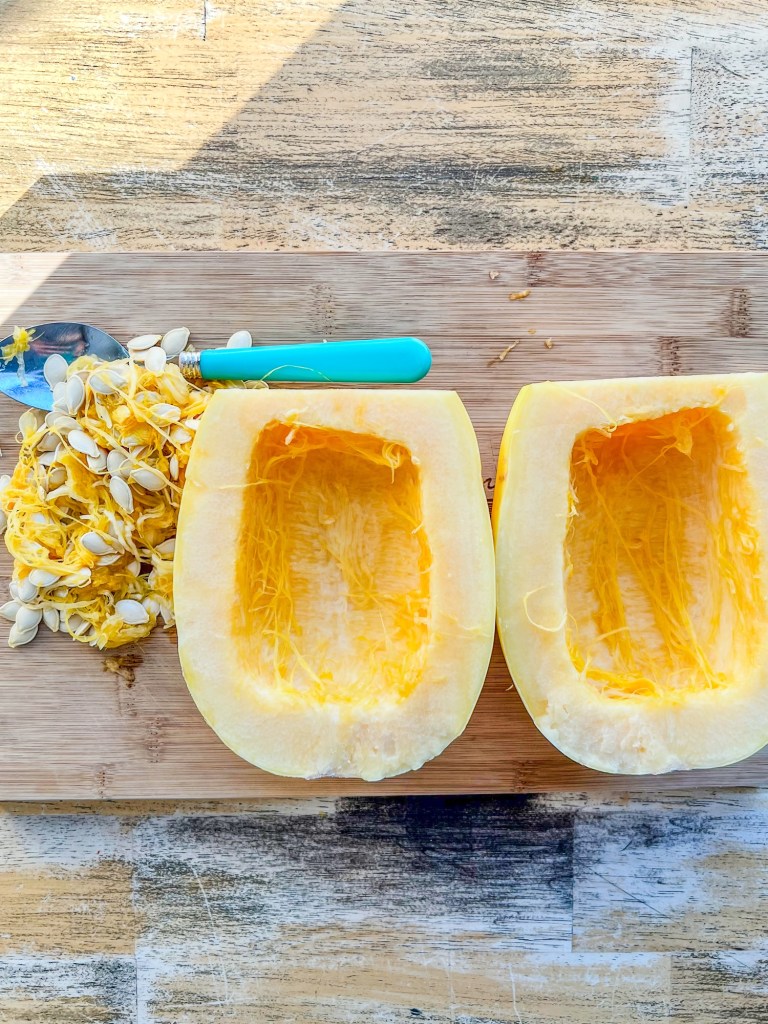 Spaghetti squash that's been halved and had the seeds scooped out of it