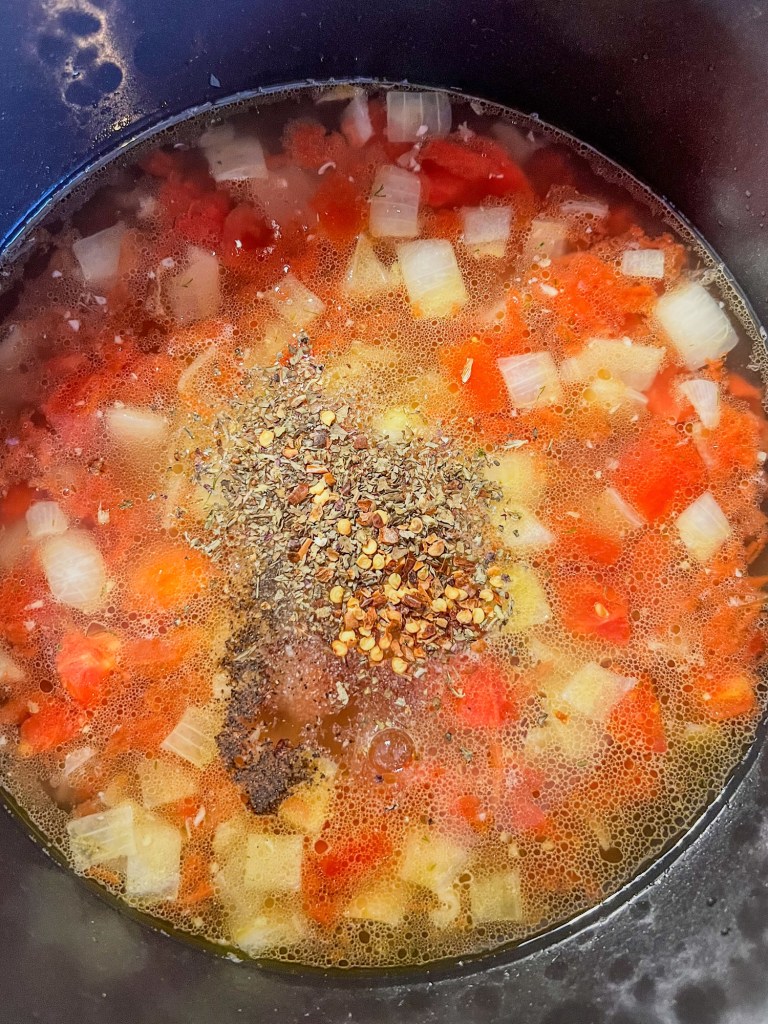 A lemony vegetable soup being built in a stockpot