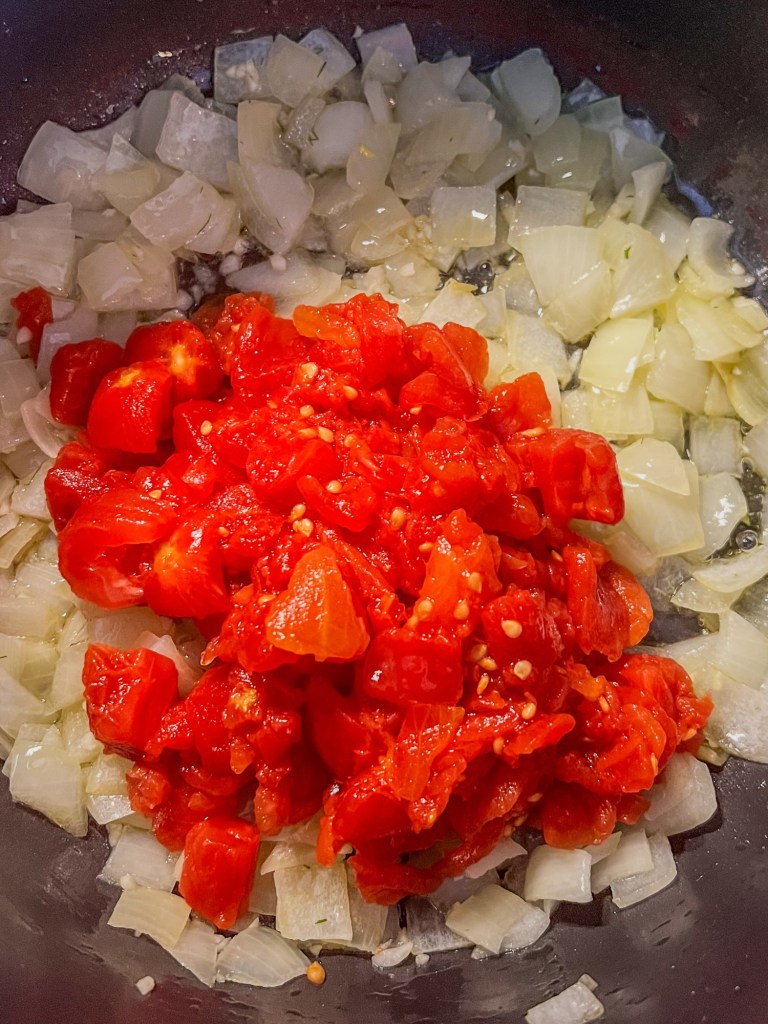 Onion, garlic, tomato, and spices in a large stockpot