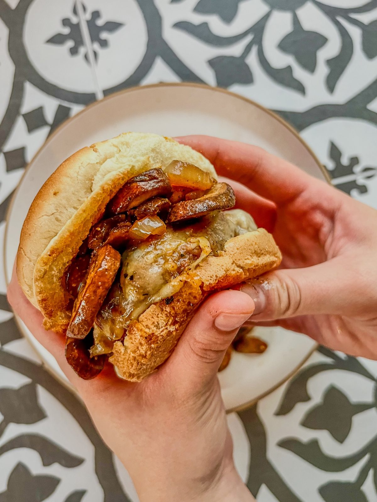 Mushroom and swiss burgers with one being held up to show the inside