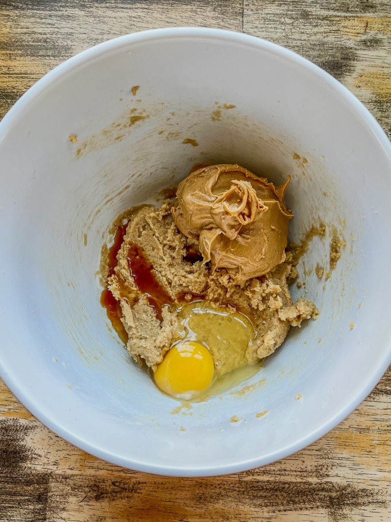 Wet ingredients for cookies in a mixing bowl before being beaten