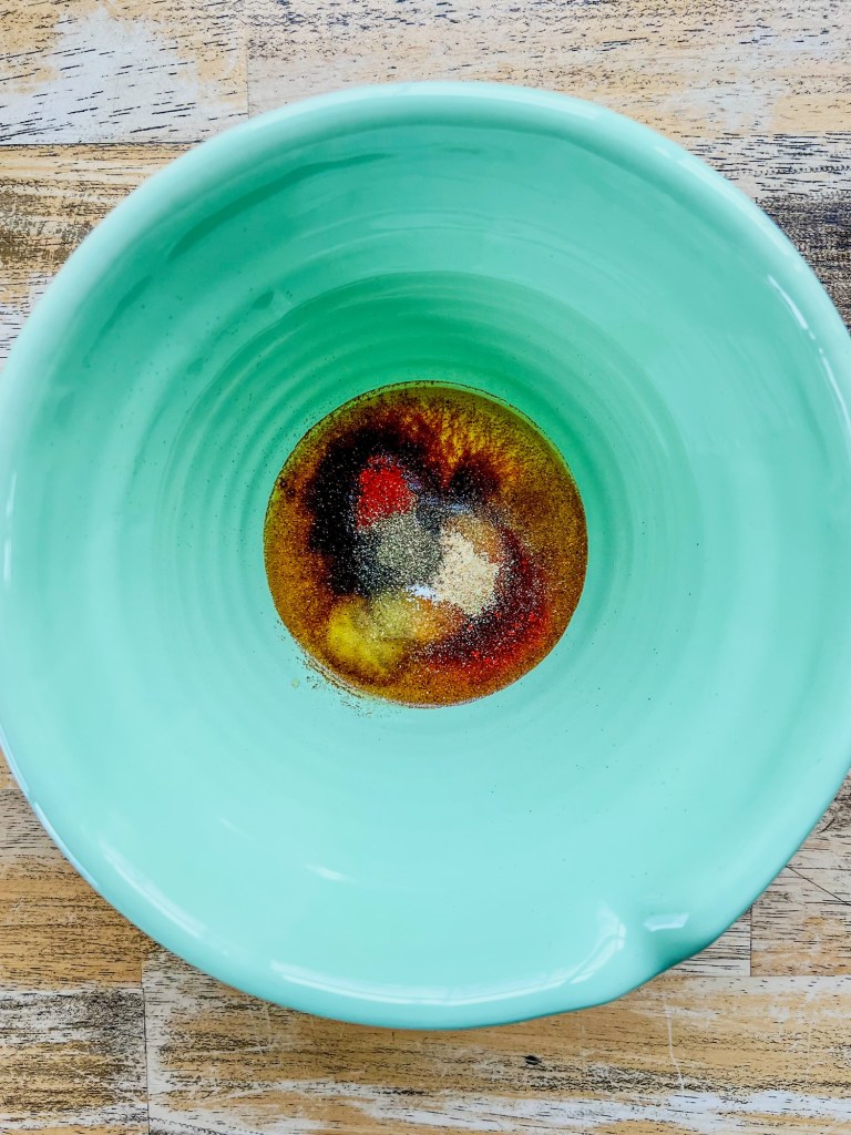 Ingredients for steak marinade in a mixing bowl before being whisked