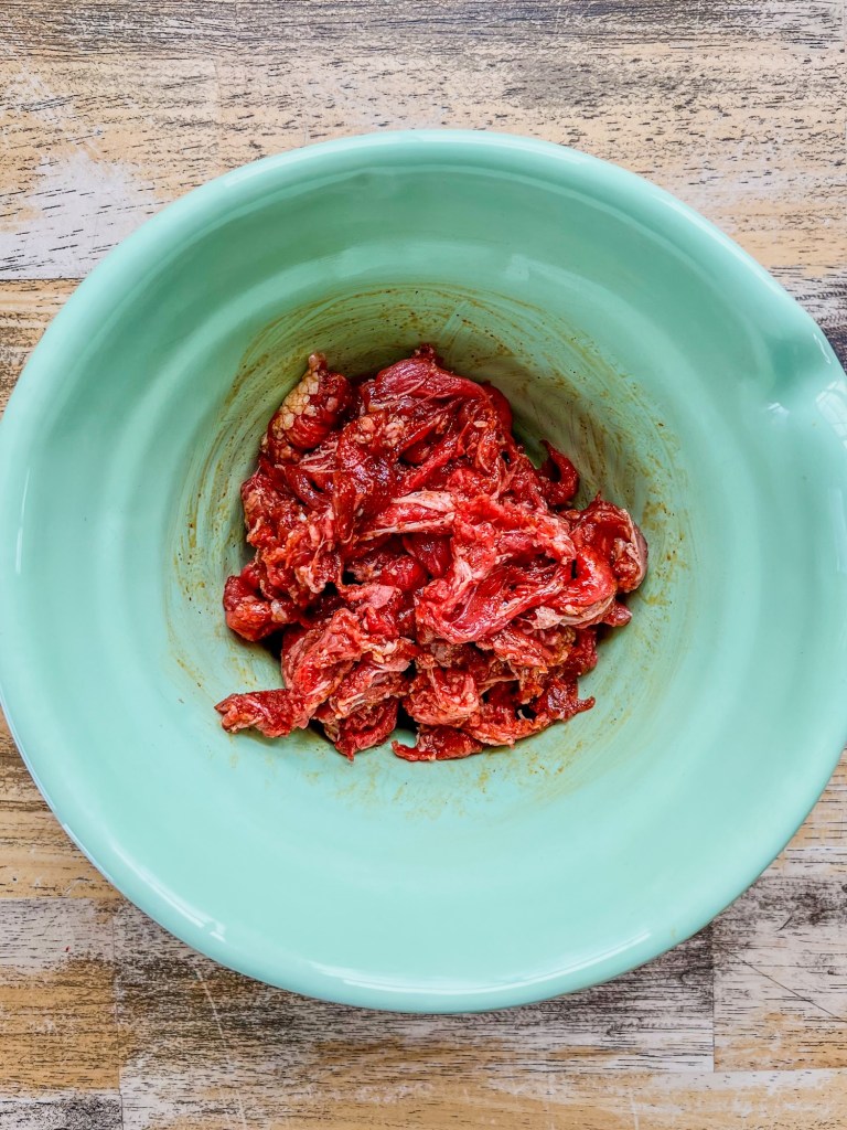 Shaved beef steak that's been tossed in a marinade