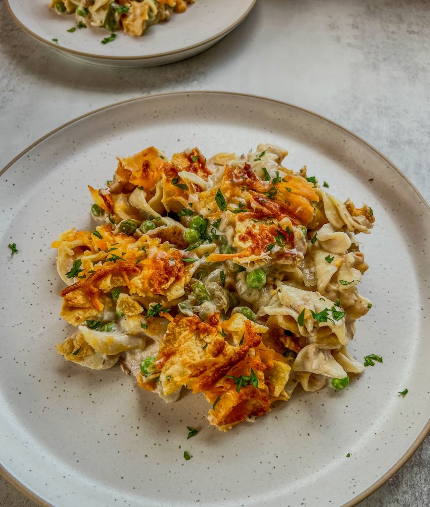 Spicy Tuna Noodle Casserole on a white plate with another plate of it behind