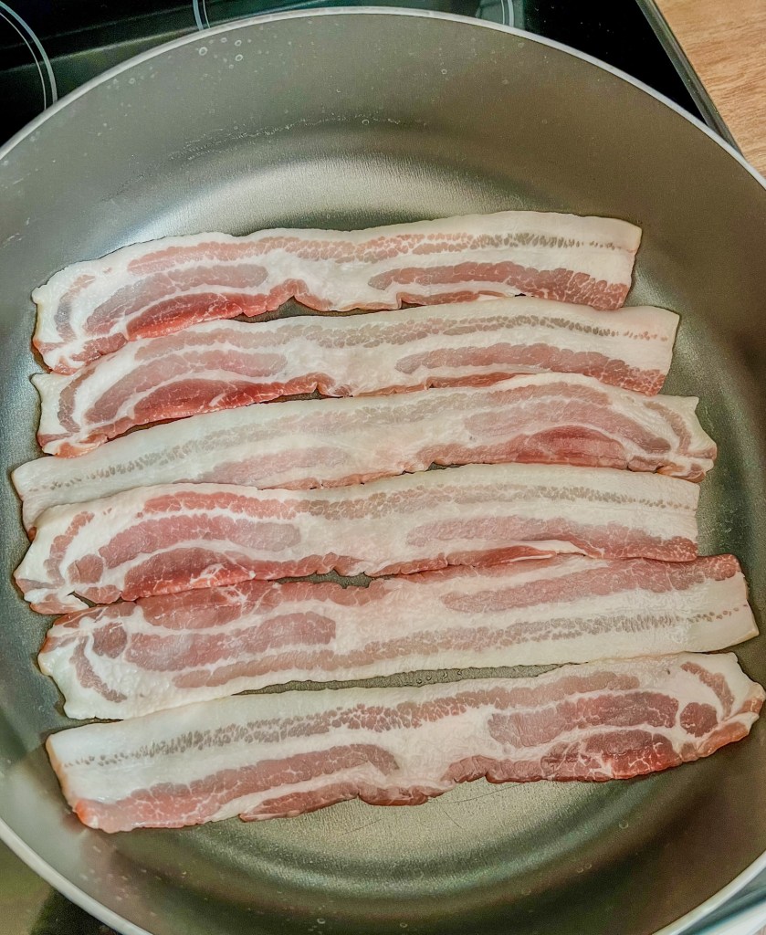 Bacon in a pan on the stove