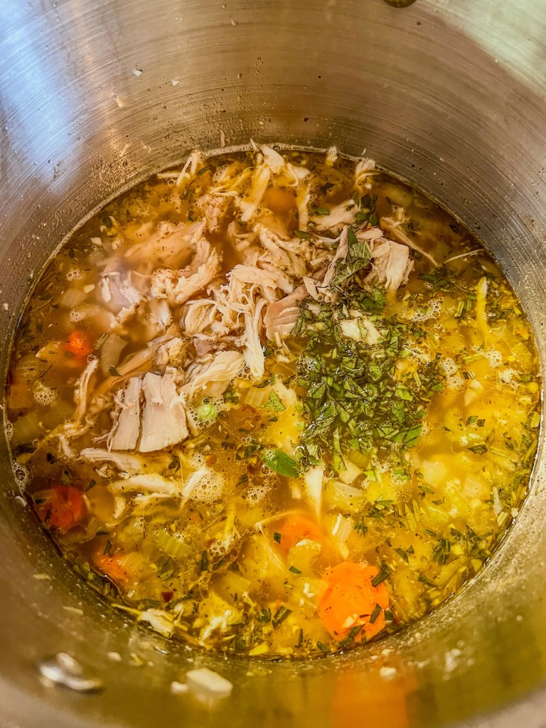 Turkey stew cooking in a large pot on the stove