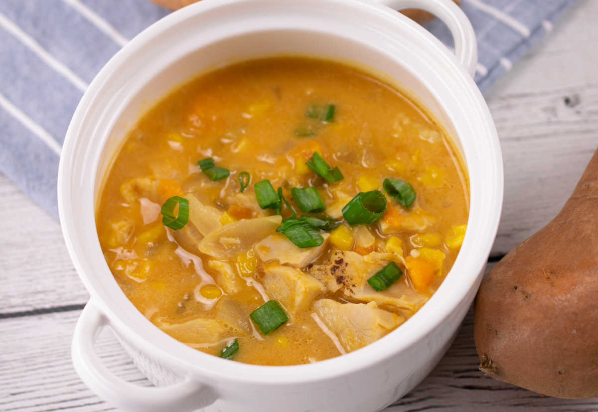 Jalapeño sweet potato chowder in a bowl with some fresh herbs on top