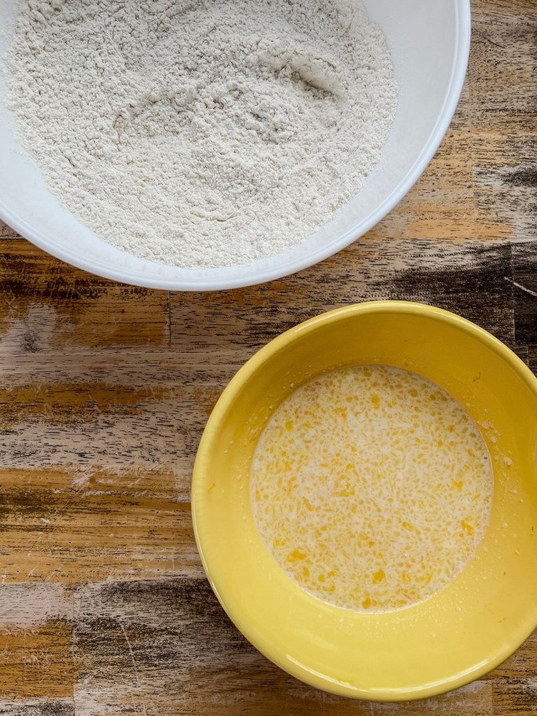 Wet and dry ingredients to make pancake batter in two separate mixing bowls