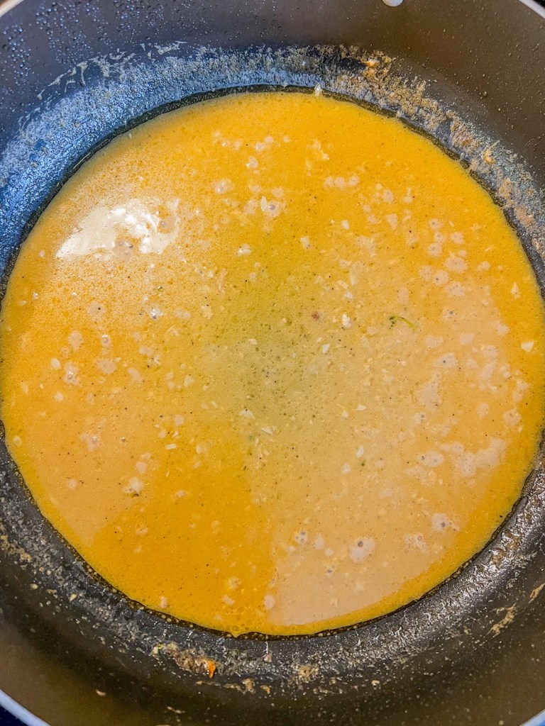 Garlic Dijon sauce simmering in a skillet