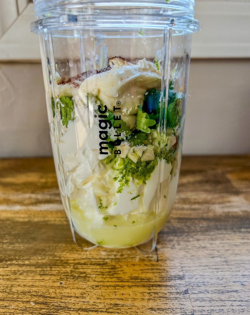 Ingredients for cilantro lime crema in a bullet just before blending