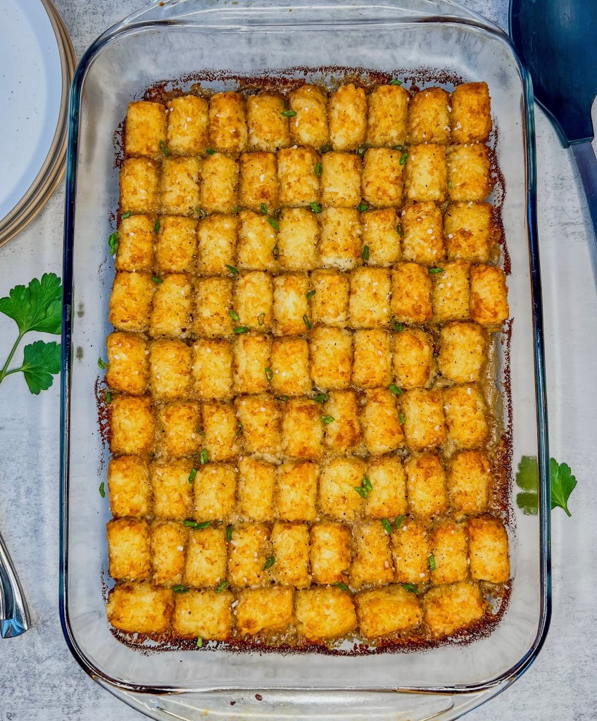 Creamy mushroom tater tot casserole fresh out of the oven with some fresh parsley scattered around