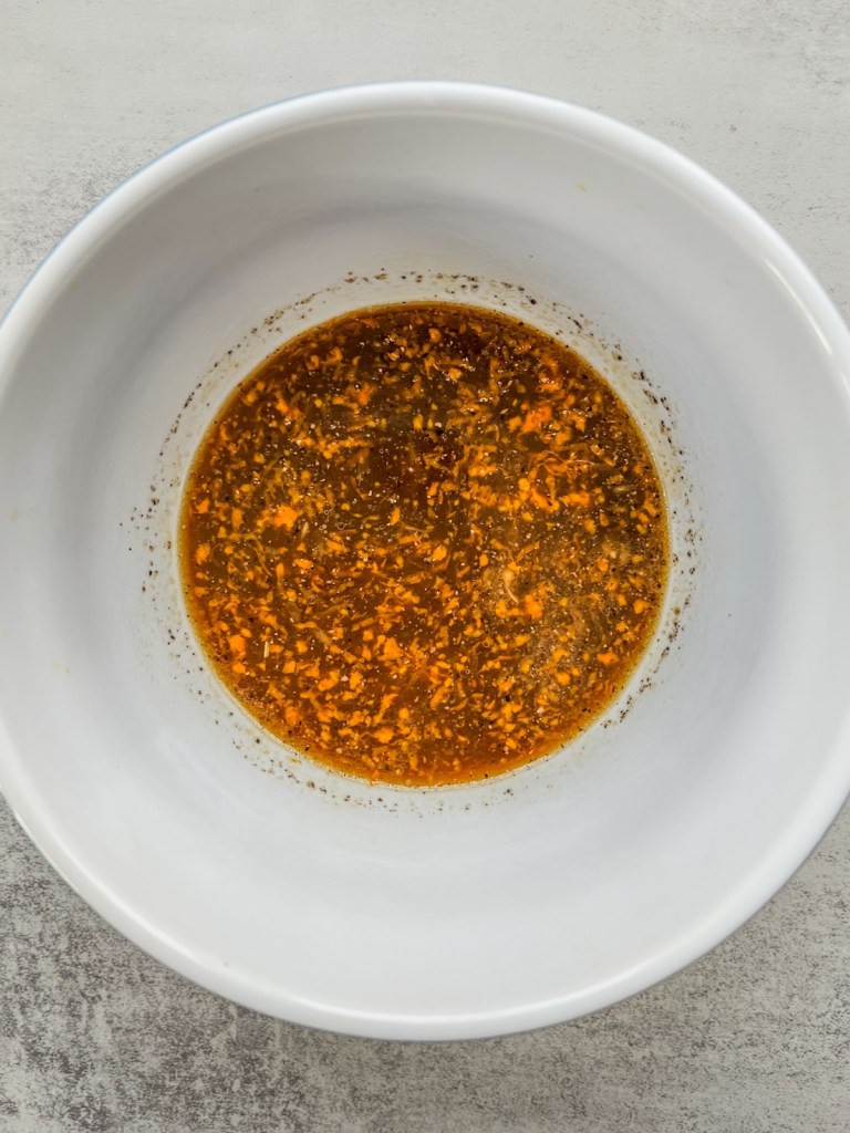 Sticky orange sauce in a mixing bowl