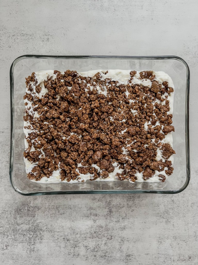 Taco dip building in a shallow dish