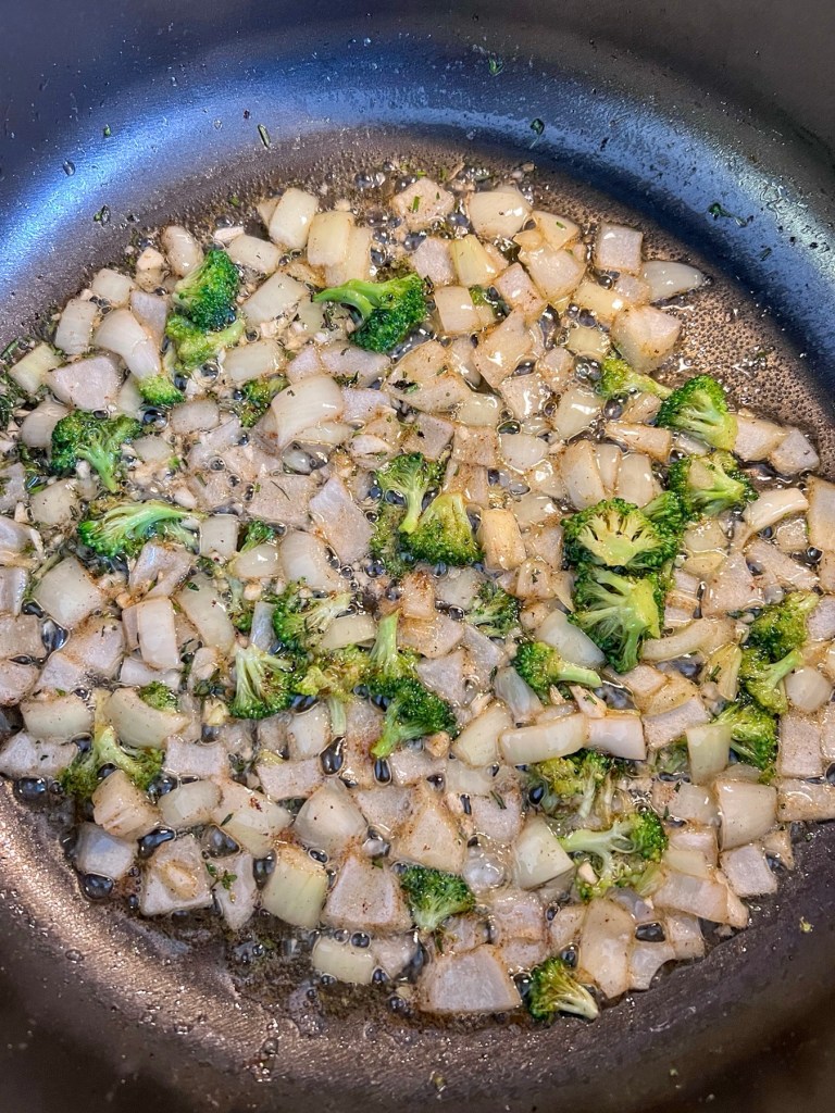 Onion, garlic, thyme, and rosemary cooking in some butter in a skillet