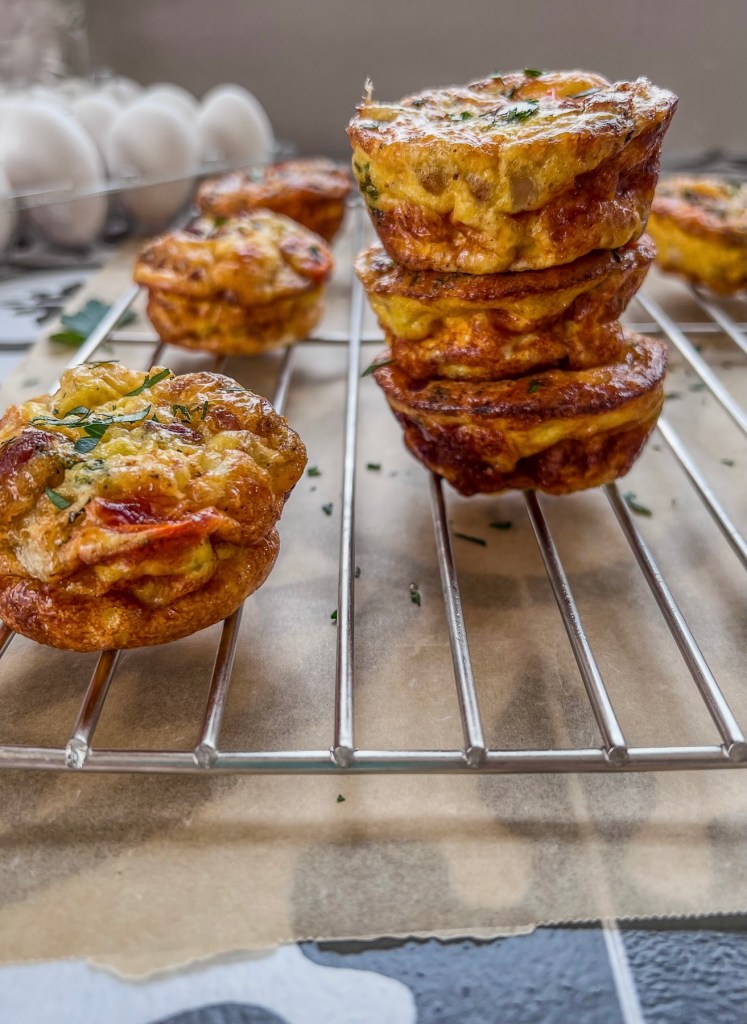 Broccoli cheddar egg cups fresh out of the oven on a cooling rack