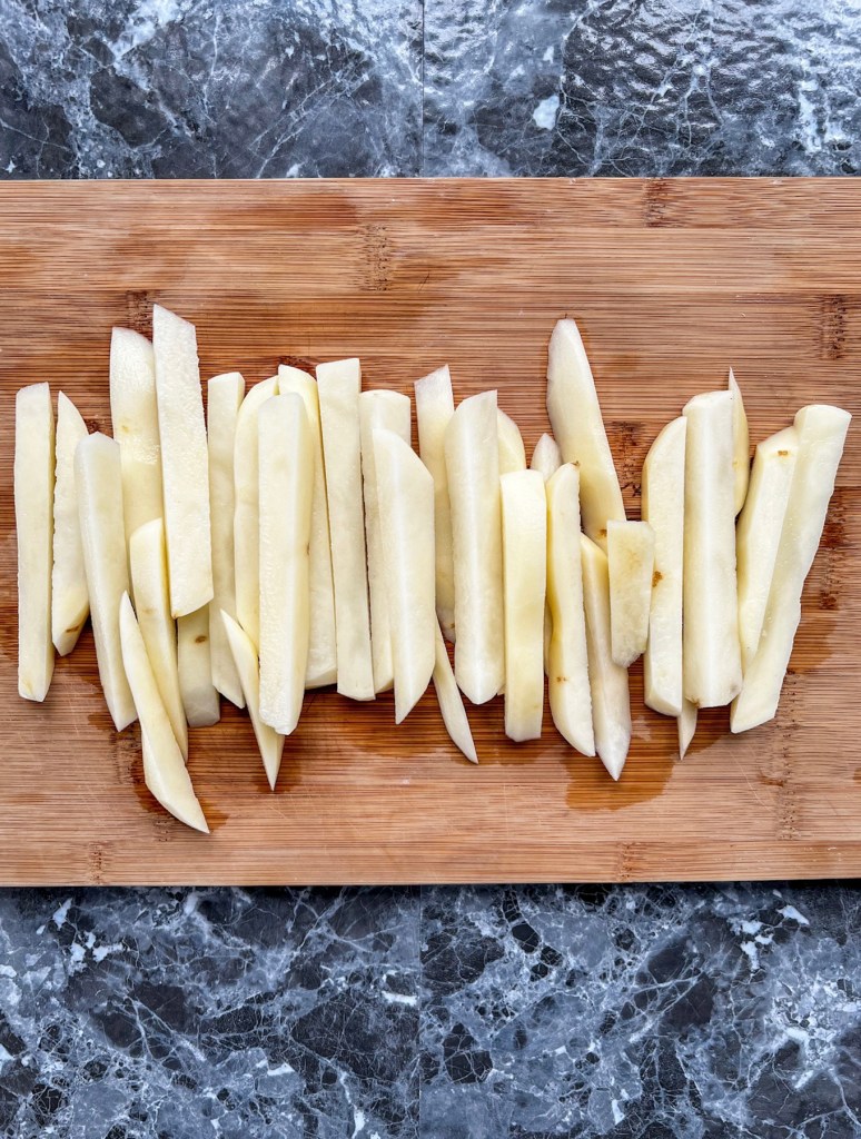 Russet potatoes cut up into sticks to make fries