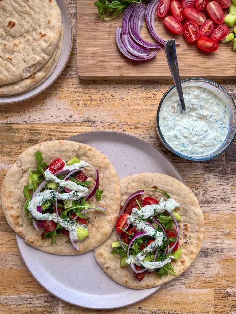 Gyros on pita bread, made with smoked sausage, fresh veggies, and a homemade tzatziki sauce