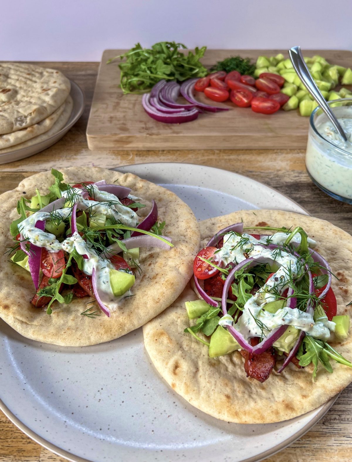 Smoked andouille sausage gyros with cucumber, tomato, red onion, dill, and a homemade tzatziki sauce drizzled over top