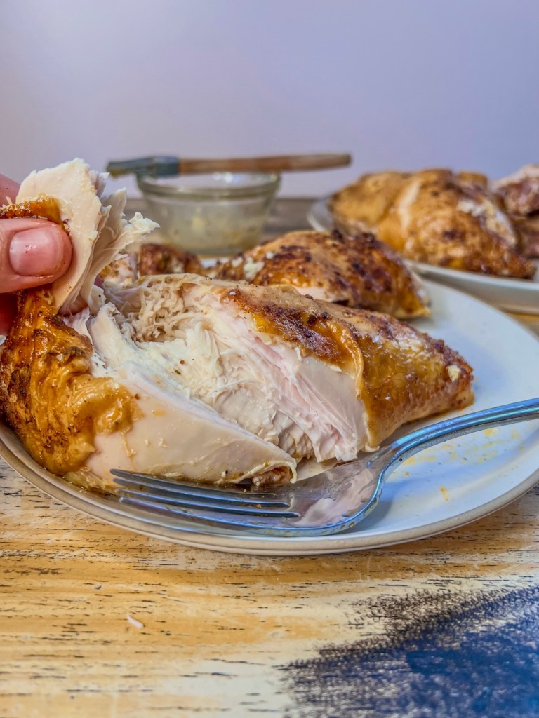 Smoked beer can chicken that's been brushed with garlic butter and served hot