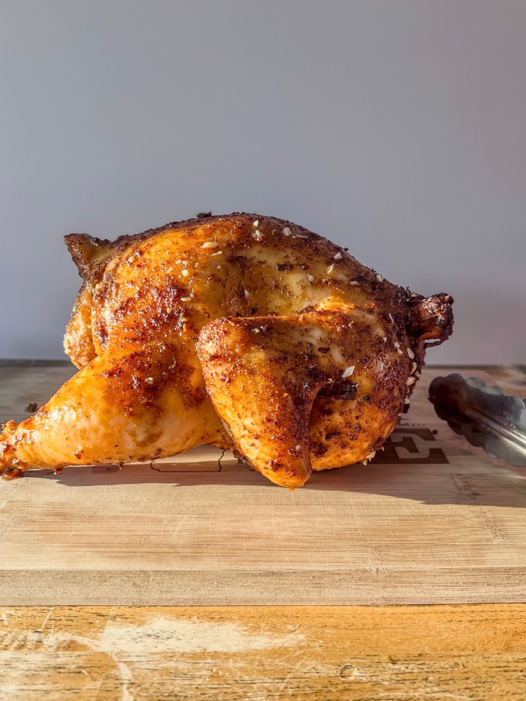 A whole chicken that's just been smoked for several hours