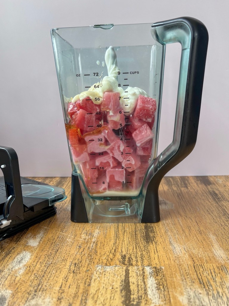Vanilla Greek yogurt, frozen watermelon cubes, honey, vanilla, milk, and salt in a blender before being blended up
