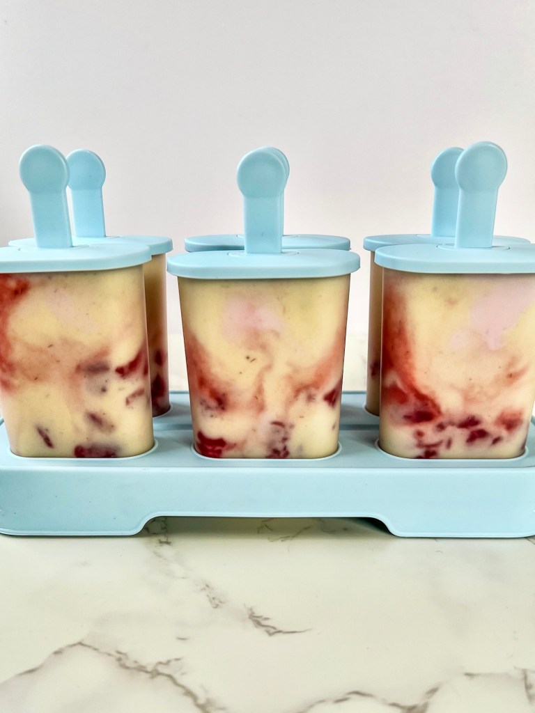 Banana split frozen yogurt pops freshly poured into molds and ready to go in the freezer